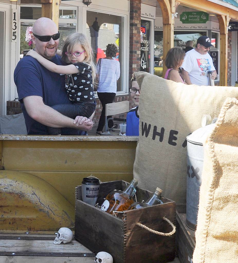 Paul Miller of Bremerton and his kids Bradley, 11, and Bridget, 4, get a look at Jeff and Billie Jo Jacksons 1966 Chevy Custom C-10 truck dubbed Skull Cracker. The Millers were visiting Sequim for the weekend. Sequim Gazette photo by Michael Dashiell