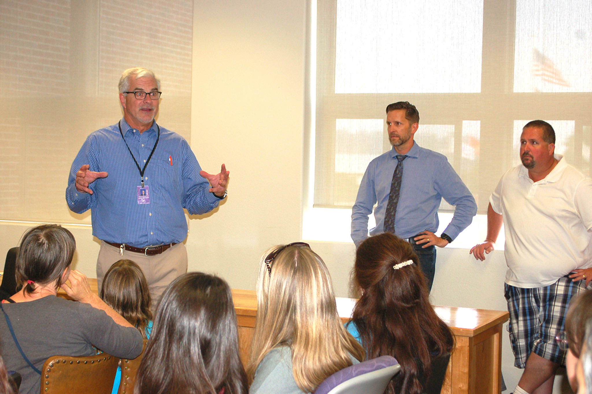 Sequim Schools Superintendent Gary Neal speaks to Olympic Peninsula Academy Parent Teacher Organization members, parents and staff on Aug. 15 at the district board room to go over details for the alternative education programs temporary housing as the district finishes its capital projects. Sequim Gazette photo by Erin Hawkins