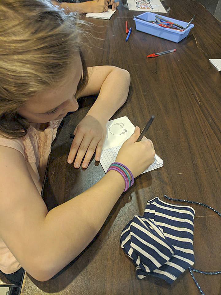 Inspired by the Diary Of A Wimpy Kid book series, a Boys & Girls Club morning camper works on her own diary. Submitted photo