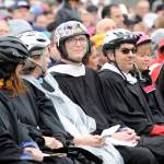 Jon Eekhoff, center, sits with his wife Cheryl, to his left, and fellow Sequim High School teachers during graduation on June 8. Teachers wore helmets in honor of him while he recovered from a cranectomy after he fell from his roof a few months prior. Sequim Gazette file photo by Michael Dashiell