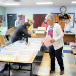Volunteers at Saturdays Back to School Fair at the Sequim Boys & Girls Club organize school supply kits for local students.