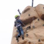 Tokgnar Davis, 6, is all smiles after reaching the top of a climbing wall at the Aug. 25 Back to School Fair in Sequim. He and twi brother Tungsten were both able to reach the top … twice. Sequim Gazette photo by Michael Dashiell
