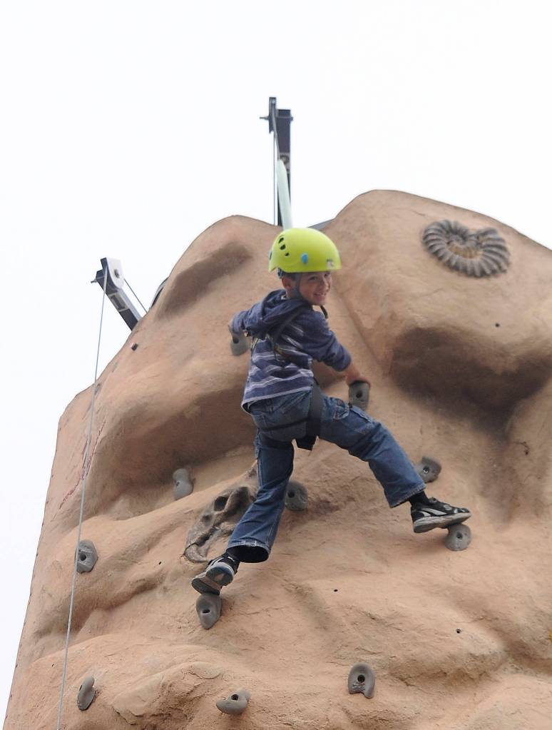 Tungsten Davis, 6, is all smiles after reaching the top of a climbing wall at the Aug. 25 Back to School Fair in Sequim. He and twin brother Tokgnar were both able to reach the top … twice.