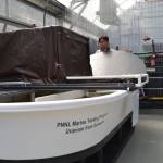 Dr. Li-Jung Kuo, a Sequim researcher, seals a tub at the Pacific Northwest National Laboratorys Marine Science Lab in Sequim where seawater constantly flows onto bundles of yarn to see how much uranium collects on the strands after about one month. Sequim Gazette photo by Matthew Nash