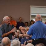Bruce Mullikin, Sunland Golf & Country Club board president, takes the microphone from Fred Smith, SunLand Owners Association president, to share updates about the financial status of the club. Im an optimistic believer we can do this, Mullikin said. Sequim Gazette photo by Matthew Nash
