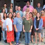 Led by Sequim School District facilitator Pam Landoni (from row, far left, the Sequim School District welcomes new staffers for the 2018-2019 school year. They include (back row, from left) Casey Lanning, Greywolf Elementary School; Alla Bess, Sequim School District; Renee Colwill, Helen Haller Elementary School; Kathryn Baulch, Helen Haller Elementary; George Rodes, Sequim Middle School; Bill McFarlen, Sequim High School; and Joclin Julmist, Helen Haller Elementary; (third row, from left) Amanda Murphy, Greywolf Elementary; Nachelle Jannetti, Helen Haller Elementary; Joey Marcey, Helen Haller Elementary; Kristi Schmeck, Sequim Middle School; Marie Claire Bernards, Helen Haller Elementary; and Ashley Kramer, Greywolf Elementary; (second row, from left) Jennifer Thatcher, Helen Haller Elementary; Melissa Sagara, Helen Haller Elementary; Doreen Minard, Helen Haller Elementary; Linda Jacobson, Greywolf Elementary; and Brooke Hoefler, Helen Haller Elementary; with (first row, from left) Landoni; Lorrie Corder, Helen Haller Elementary; Johanna Mitchell, Sequim Middle School; Jasmine McMullin, Helen Haller Elementary; and Lora Rudzinski, Greywolf Elementary School. Not pictured are Leanne Felts and Norma Graham. Photo by Hanna Smith/Sequim School District
