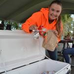 Heidi OLeary readies another meal for a child at Carrie Blake Community Park through the Summer Food Program for Children. OLeary said on average, the program provided 30-50 meals for children this summer except in smoky weather when less people went outside. Sequim Gazette photo by Matthew Nash