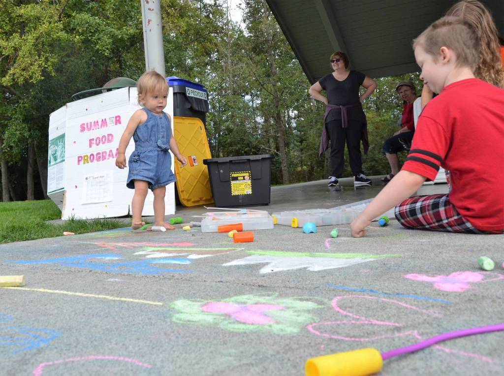 Josie Brocklesby, 15 months, enjoys some chalk before eating some lunch care of the Boys & Girls Clubs of the Olympic Peninsula and the US Department of Agricultures Summer Food Program for Children. Sequim Gazette photo by Matthew Nash