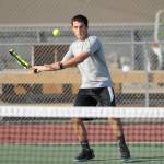 Sequims Thomas Hughes returns a shot in a straight-set win over Port Angeles Jason Seibel on Sept. 6, the season and Olympic League opener for the Wolves. Sequim Gazette photo by Michael Dashiell
