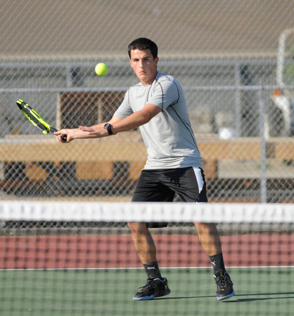 Sequims Thomas Hughes returns a shot in a straight-set win over Port Angeles Jason Seibel on Sept. 6, the season and Olympic League opener for the Wolves. Sequim Gazette photo by Michael Dashiell
