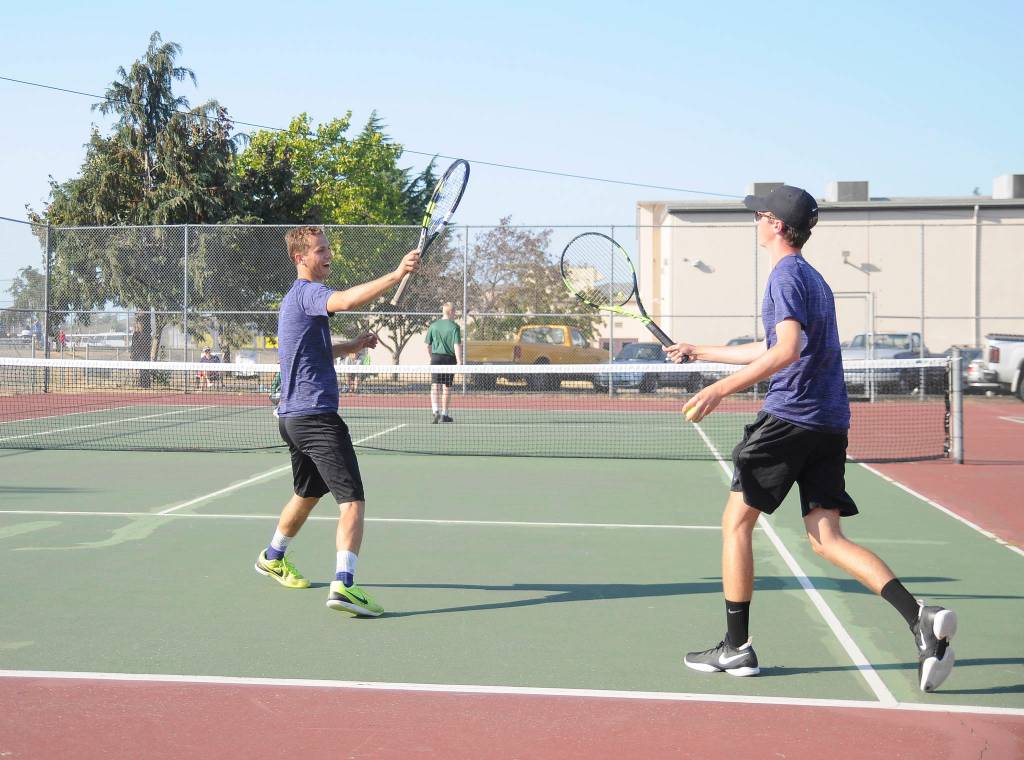 Sequims Liam Payne, left, and partner Damon Little celebrate a point as they earn a come-from-behind, three-set win over Port Angeles Brady Nickerson and Kyler Torbin in No. 1 doubles action on Sept. 6. Sequim Gazette photo by Michael Dashiell