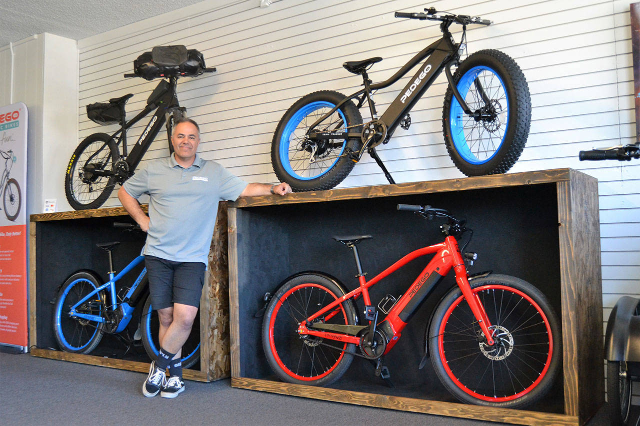 Garth Schmeck offers free rides, rentals, and sales of Pedego electric bikes in his new downtown shop Pedego Sequim. He said e-bikes help alleviate peoples fears of hills and distances. Sequim Gazette photo by Matthew Nash