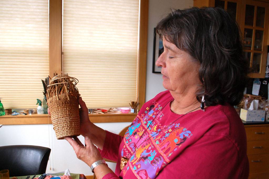 Cathy MacGregor is a local tribal elder that recently became an apprentice to renowned Haida weaver Lisa Telford. She holds a cedar basket she weaves as practice for her apprenticeship. Sequim Gazette photo by Erin Hawkins