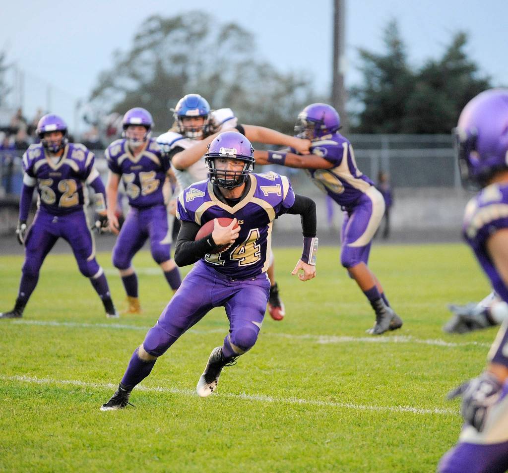 Sequim High quarterback Riley Cowan looks for running room in the Wolves win over North Mason last week. Cowan had 61 of Sequims 211 rushing yards. Sequim Gazette photo by Michael Dashiell