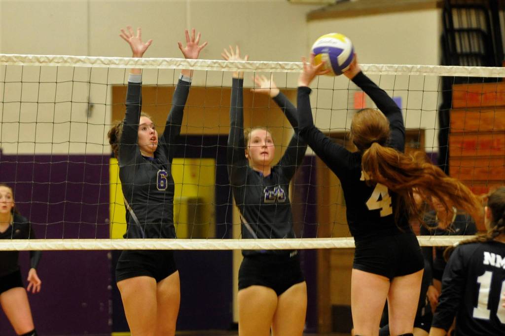 Sequims Brittany Gale, left, and Arlene look to block a shot by North Mason hitter Hannah Fredrickson in a Sept. 25 Olympic League match-up. Sequim Gazette photo by Matthew Nash
