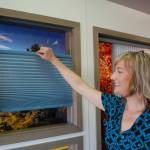 Alicia Ennen, window covering consultant at The Blind Store by McCrorie, shows how one of the stores top-down bottom-up cellular shades work and can be adjusted from the top or bottom of the shade. Sequim Gazette photo by Erin Hawkins