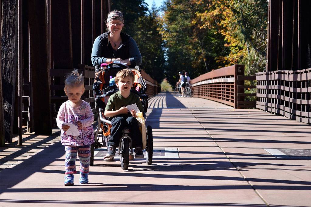 Rebekah Brooks walks with her children Luke, 5, and Allison, 2, on the Dungeness River Railroad Bridge during the Dungeness River Festival.