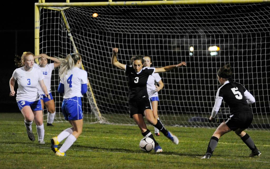 Sequim defender Yana Hoesel (3) clears the ball from deep in Wolves territory and negates a Bremerton scoring chance late in the first half of Sequims 3-0 win over the Knights. SHSs Mary McAleer (5) looks on. Sequim Gazette photo by Michael Dashiell