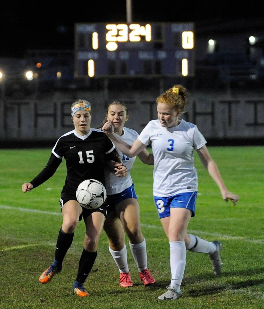 Sequims Autumn Hilliard, left, keeps the ball from Bremertons Jessica Linkemyer (11) and Sophia Capedon (3) midway through the first half of the Wolves 3-0 win on Oct. 4. Sequim Gazette photo by Michael Dashiell