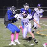 Sequim defensive lineman Austin Newton tries to wrap up Olympic running back Malcolm DeWalt in the first half of Sequims 28-9 win in Silverdale on Oct. 5. Sequim Gazette photo by Michael Dashiell