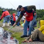 Jamie and Gibson Hill of Sequim pull in a fish while Dave Dewald tries to net it at Kids Fishing Day in 2016. Organizers of the event plan to hold it May 19, 2018, but they hope to move the event to another pond in 2019 to preserve the fish in hot weather. Matthew Nash/Olympic Peninsula News Group