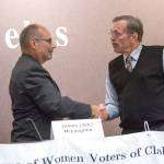 Candidates for Clallam County sheriff Jim McLaughlin, left, and incumbent Bill Benedict shake hands following the League of Women Voters forum Wednesday. (Jesse Major/Peninsula Daily News)