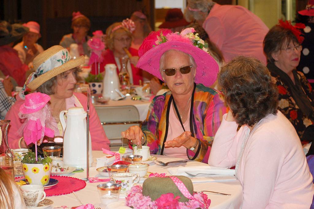 M.J. Anderson, left, converses with Melody Albertson, Mad Hatters committee secretary, and Barb Flavin, over tea at the 21st annual Mad Hatters tea party and luncheon on Oct. 5. at Sequim Community Church. Sequim Gazette photo by Erin Hawkins