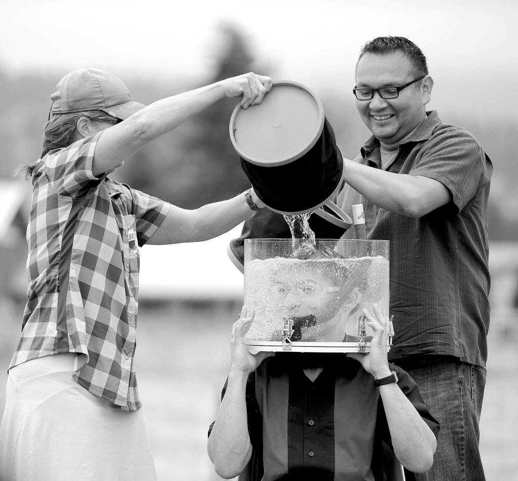 Martha Wise of Carson City, Nev., and teacher Chris Stevens of Sequim help magician Jeff Evans with an underwater trick on June 27, 2017. The photo, Tanks for the Magic Act, took third place in the the 2018 WNPA Better Newspaper Contests Photography-Feature Portrait or Pictorial (black and white) division. Sequim Gazette photo by Michael Dashiell