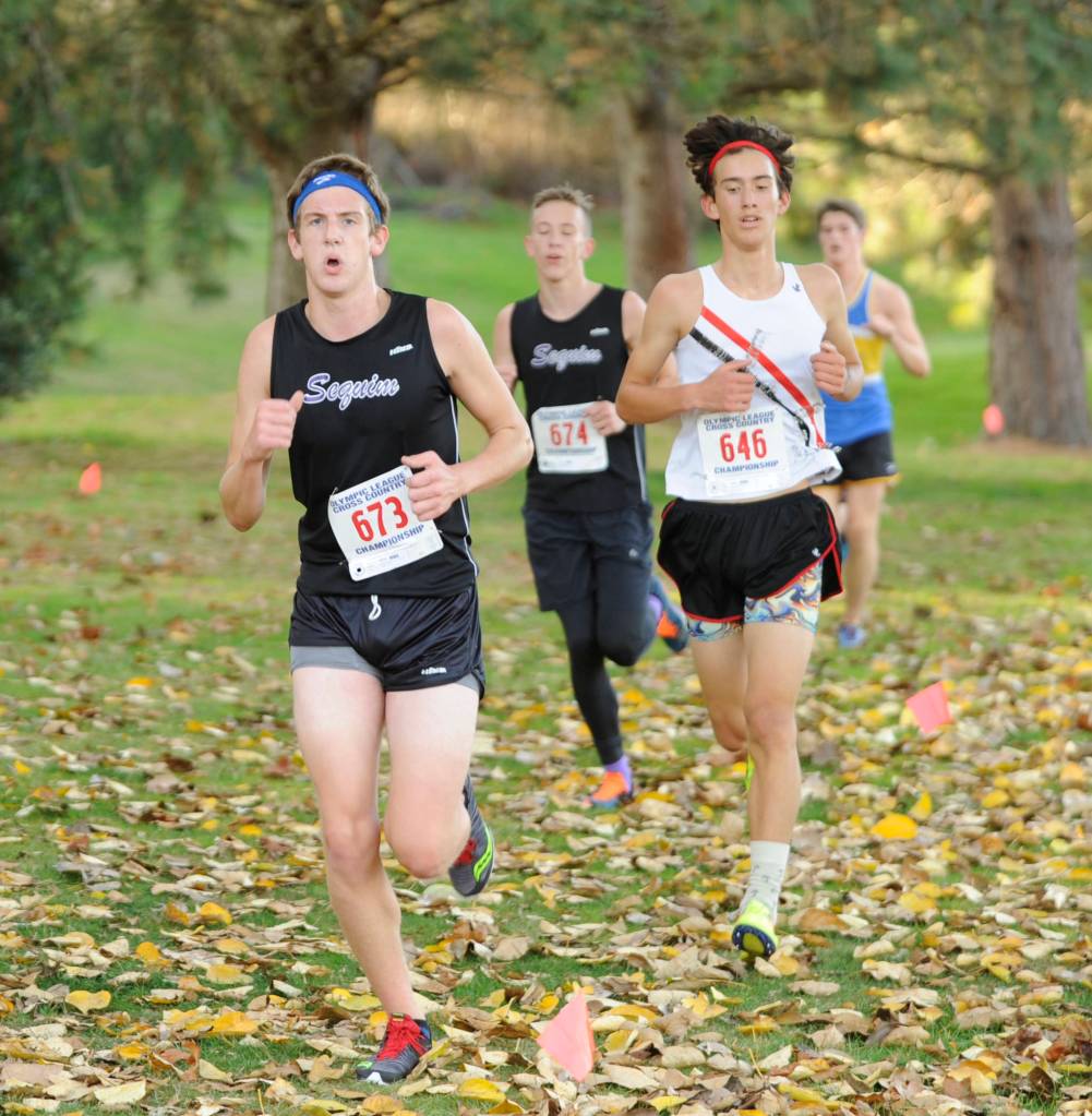 Sequim Highs Fischer Jensen, left, and Jakob Pyeatt (background) compete at the Oct. 18 Olympic League meet in Port Townsend. The Wolves placed sixth, fourth among 2A schools, and will look for a team berth to state at districts on Oct. 27. Sequim Gazette photo by Michael Dashiell