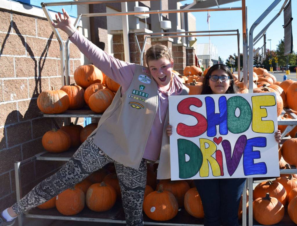 On Oct. 18, girl scouts Paige Krzyworz and Mya Spalding and five other girls helped bring in more than 130 pairs of shoes for foster children in Clallam County at the Sequim Walmart. Submitted photo