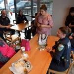 Roni Lavatai, on left, speaks with Sequim Police officer Maris Larsen during Coffee with a Cop on Oct. 23 in the Sequim Starbucks. Sequim Gazette photo by Matthew Nash
