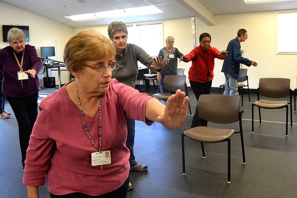 Tai Ji Quan continues at the YMCA through Olympic Medical Centers Wellness Services program. Here, participants, from left, Helen Butler, Peggy Scheideler, physical therapist, Sandy Sullivan, Sarah Thomas, Peggy Dawson, and Richard Thomas move together in the 23rd week of a 24 week class to help prevent falls. Sequim Gazette photo by Matthew Nash