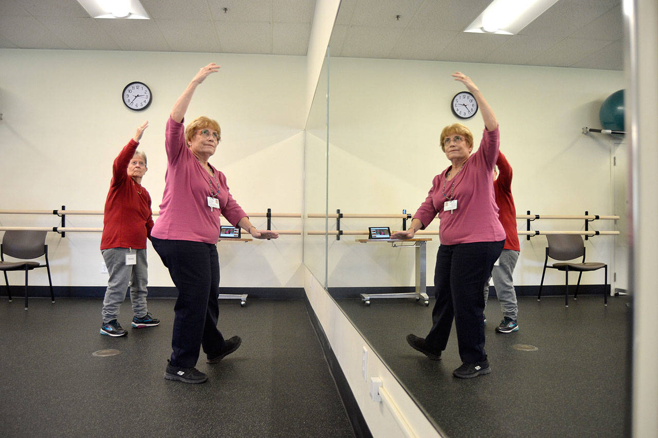 Peggy Scheideler, a physical therapist, on right, leads a class in Tai Ji Quan, including Roberta Prentice in the YMCA of Sequim to help with balance and prevent falls. This was the first class offered through Olympic Medical Centers partnership with the YMCA for its Wellness Services. Sequim Gazette photo by Matthew Nash