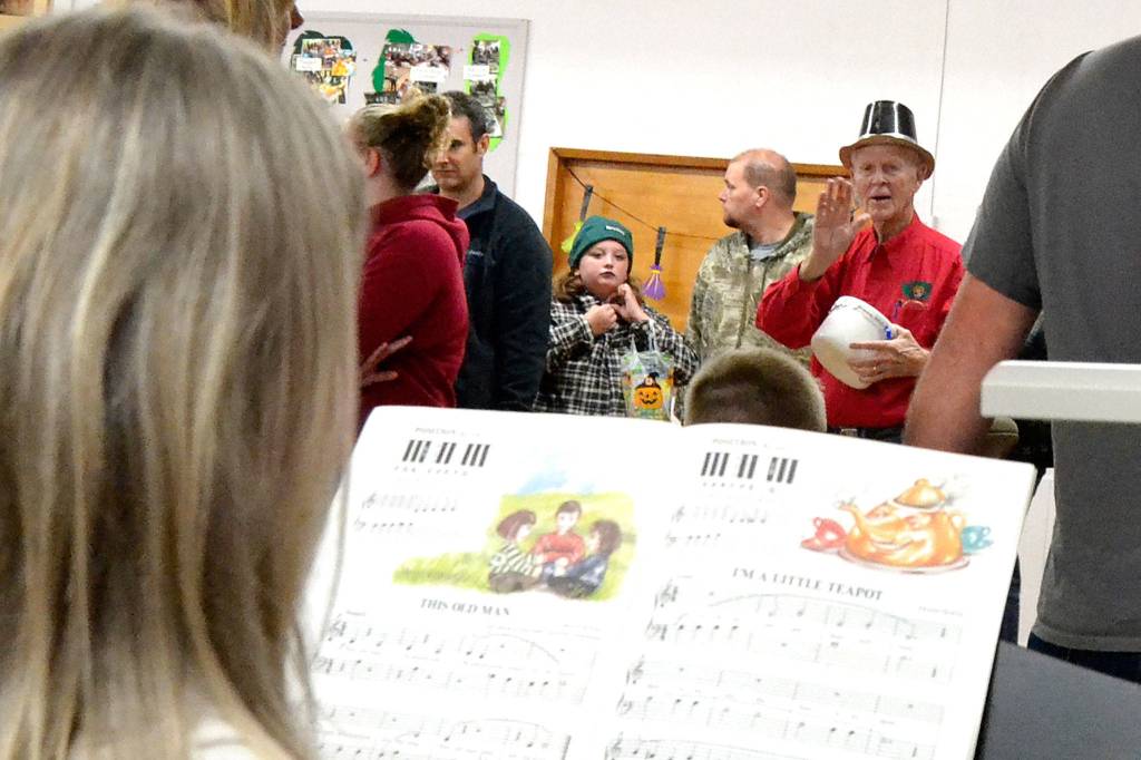Bob Clark signals to Vicki Lowe to stop the music for the Cake Walk so that he can choose a winner during the Sequim Prairie Granges Country Fair. Lowe played multiple songs including Im a little Teapot and This old Man. Sequim Gazette photo by Matthew Nash
