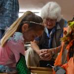 Aubrey Riley, 5, of Sequim searches for treasure as Helen Bucher watches at the Sequim Prairie Granges Country Fair. Sequim Gazette photo by Matthew Nash