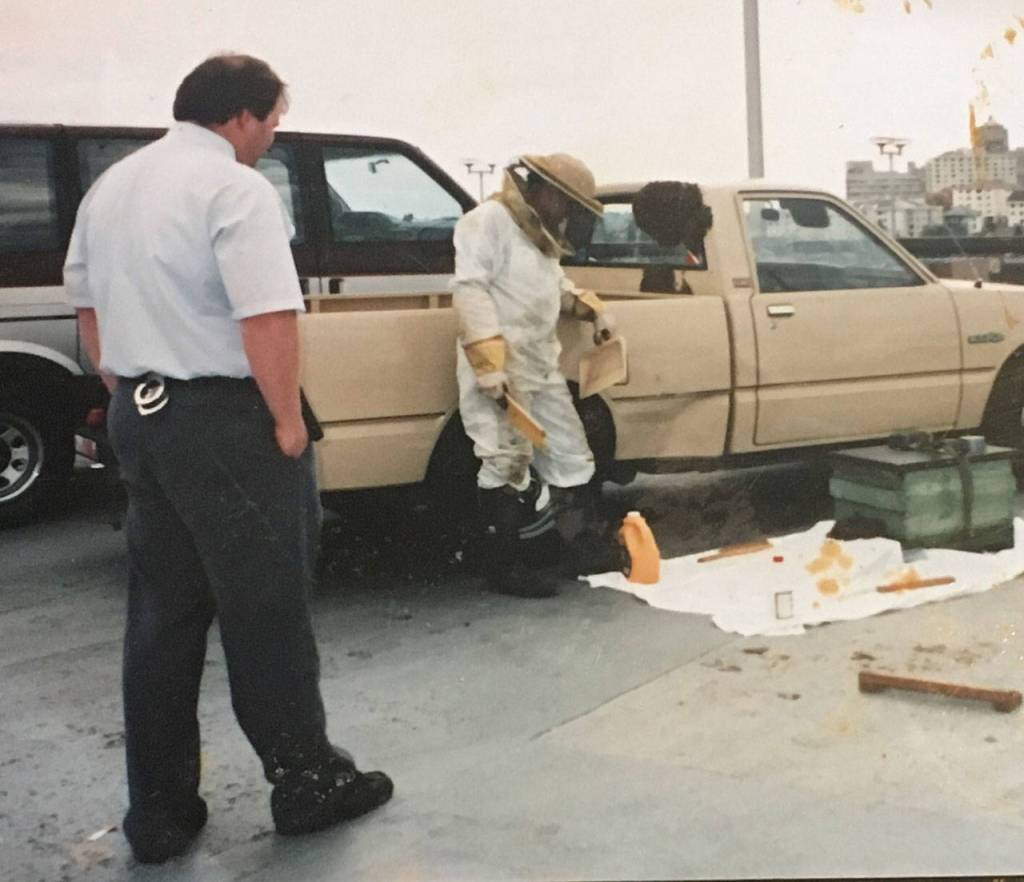 Buddy DePew watches as a beekeeper safely removes honey bees from his truck 30 years ago from a parking garage in Seattle. DePew said the incident may have helped lead to his interest in beekeeping. Photo courtesy of Buddy DePew
