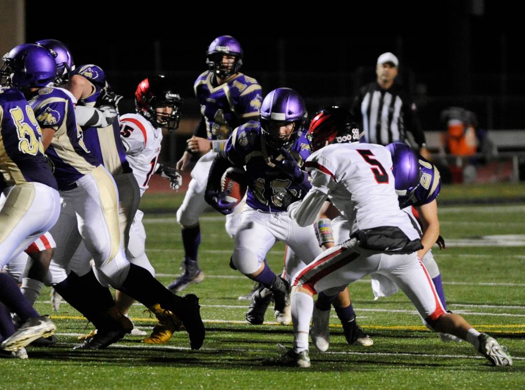 The Wolves offensive lines opens a hole for Sequim running back Taig Wiker against Franklin Pierce in a West Central District playoff game on Nov. 2. Wiker had 98 yards rushing to lead Sequim, as his quad edged Franklin Pierce 22-20. Sequim Gazette photo by Michael Dashiell