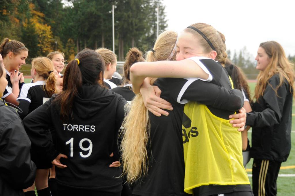 Sequims Abby Schroeder, right and Eden Johnson share a hug following the Wolves district title clinching win on Nov. 3. Sequim Gazette photo by Michael Dashiell