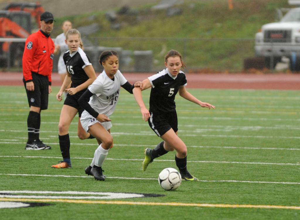 Sequim sophomore defender Mary McAleer looks to keep the ball from North Kitsap forward Kamora McMillan. Sequim Gazette photo by Michael Dashiell