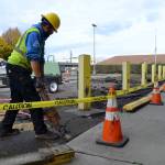 Colbi Bruni with Lakeside Industries jack hammers the old pavement in front of the Sequim Post Office on Halloween. He and other crewmen worked over two days to resurface the parking lot.