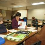 Olympic Peninsula Academy seventh-grade students Basil Sisson, left, and Austin Parker, right, listen as math and science teacher Nessa Gouldman teaches a math concept in one of OPAs new portables. Sequim Gazette photo by Erin Hawkins