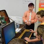 Aiden Johnson, left, talks to fellow Computer Club members Quentin Bennett and Andre Campbell about the operational suitcase computer created by Sequim PC Users Group for demonstrations and classes like the club at Roosevelt Elementary. Sequim Gazette photo by Matthew Nash