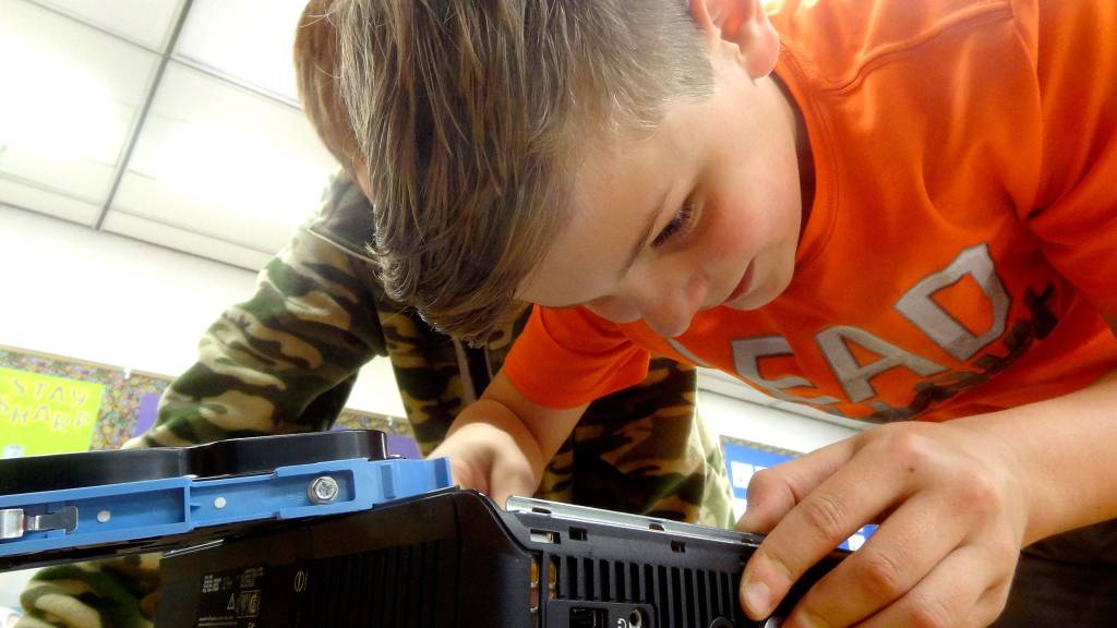 Quentin Bennett works to rebuild a computer in October during Roosevelt Elementarys Computer Club presented by the Sequim PC Users Group. Photo courtesy of Dick Wolf