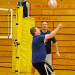 As Sequim High principal Shawn Langston looks on, teacher Jorn VandeWeghe goes no-look on his hit over the net at last weeks inter-school rivalry game. Officiating is Lillian Ode, a Sequim High graduate and volleyball coach. Sequim Gazette photo by Michael Dashiell