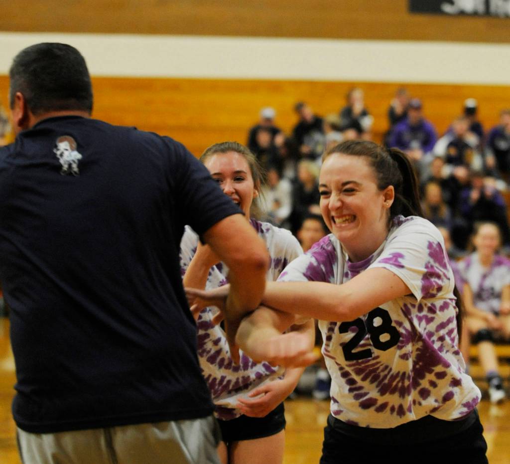 Sequim High seniors Tayler Breckenridge, right and Brittany Gale share a laugh with Shawn Langston after the SHS principal blocked a seniors hit at last weeks Seniors-Versus-Staff game. Sequim Gazette photo by Michael Dashiell