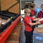 Corrine Wallen of Sequim with her sons Drew, 9, and Aaron, 12, select some healthy options for their Thanksgiving meal at the Sequim Food Bank, Drew said he loves eating turkey and Aaron loves slobbering pumpkin pie in whipped cream.