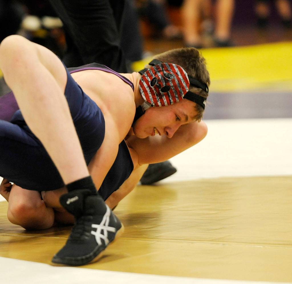 Above, Sequims Jacob Pyeatt closes in on a first-round pin of Bremertons Chris Lane in the All-Comers tournament in January. Pyeatt is the lone returning upperclassman for the SHS boys wrestling program this season. Right, Sequims Amaran Sauiluma works for a pin late against North Masons Josh Raymond in the 185-pound weight division at the All-Comers prep wrestling tournament in Sequim during the 2017-2018 season. Sauiluma is one of just five returning boys wrestlers for the Wolves. Sequim Gazette file photos by Michael Dashiell