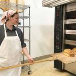 Amy Arnold, a baker of 16 years and co-owner of Two Spot Bakery in Sequim, pulls a fresh loaf of sourdough bread out of a large oven in the business new space at 173 West Bell St. Sequim Gazette photo by Erin Hawkins                                Amy Arnold, a baker of 16 years and co-owner of Two Spot Bakery in Sequim, pulls a fresh loaf of sourdough bread out of a large oven in the business new space at 173 West Bell St. Sequim Gazette photo by Erin Hawkins
