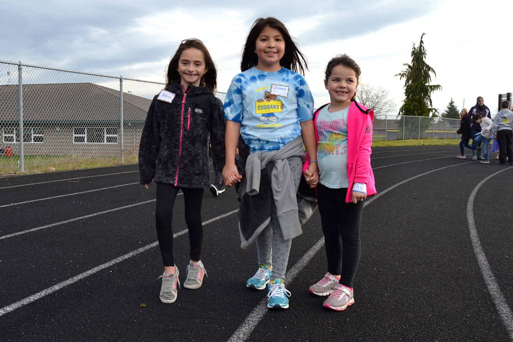 Helen Haller Elementary students Addison Carver, Johonna Chavez and Aubri Miller round a corner all smiles at the schools Turkey Trot on Nov. 21.