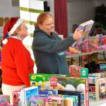Last year, Toys for Sequim Kids helped bring toys to nearly 400 Sequim children, including Lori Seimers children. Here she looks for toys with Anne Notman, a volunteer with Sequim Community Aid in 2017. Donations continue through Dec. 10 around the community. Sequim Gazette photo by Matthew Nash